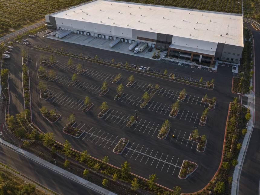 Aerial of a freshly striped distribution facility parking lot at sunset